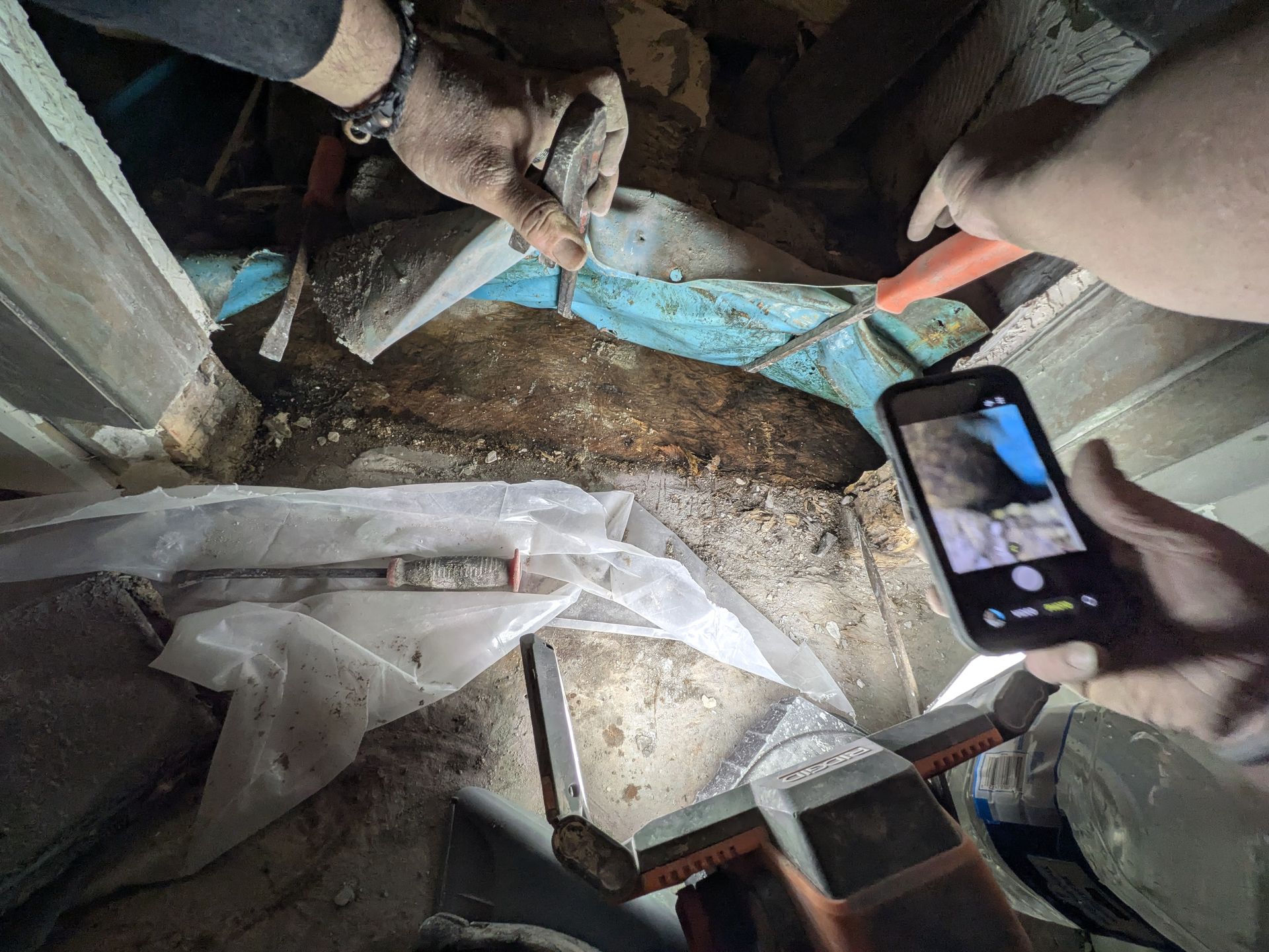 Inspecting bathroom plumbing from the crawl space in Athens GA
